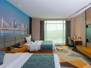 a hotel room with two beds and a desk at Chonpines Hotel Guangzhou Sunac Cultural and Tourism City Shiling in Huadu