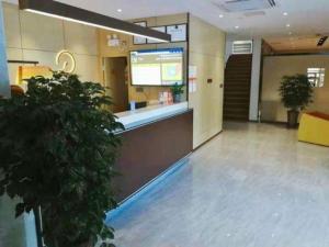 a lobby with a waiting area in a building at IU Hotel·Tianjin Binhai New District Yanghuo Market in Binhai