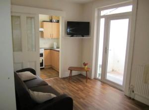 a living room with a couch and a table at Durley house in Alphington