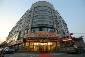 a large building withinese writing on the front of it at Vienna Hotel Inner Mongolia Hohhot Railway Station Gongzhufu Metro Station in Hohhot