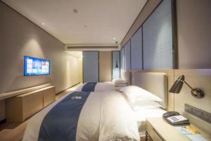 מיטה או מיטות בחדר ב-Echarm Hotel Fuzhou Yantai Mountain Olympic