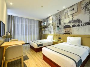 Ένα ή περισσότερα κρεβάτια σε δωμάτιο στο City Comfort Inn Wuhan Wuhan Ring Sports Center Airport