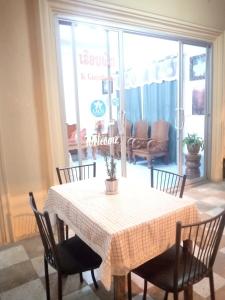 une salle à manger avec une table et des chaises et une chambre avec dans l'établissement KhopChai Guesthouse, à Houei Sai