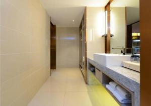 a bathroom with a sink and a mirror and a counter at Echarm Hotel Wuhan Huangpu Erqi Xiaolu Metro Station in Jiang'an