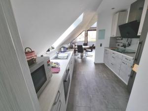 a kitchen with a sink and a stove top oven at Ferienwohnung Wahler in Ramsthal