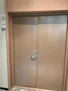 a metal door with a handle in a building at Borrman Hotel Liuzhou Guizhong Avenue Liugao in Liuzhou