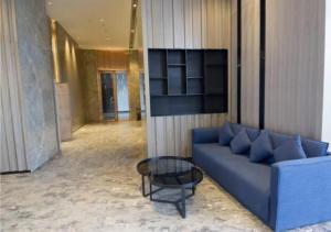 a blue couch and a table in a lobby at Echarm Hotel Beihai Yintan in Dianbailiao