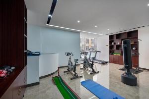 a gym with treadmills and exercise bikes in a room at Laog hao hotel in Shunde