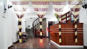 a person sitting in a chair in the hallway of a house at Bích Ngọc Hotel Hà Nội in Hanoi +31 photos