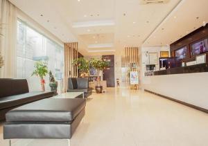 a lobby with couches and plants in a building at City Comfort Inn Liuzhou The Mixc Xijiang Road in Liuzhou