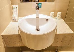 a bathroom sink with a faucet on a counter at City Comfort Inn Liuzhou The Mixc Xijiang Road in Liuzhou
