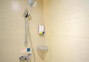 a shower in a bathroom with a shower head at City Comfort Inn Jingzhou Hongxing Road Food Street in Pu-ho