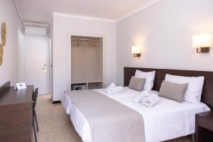 Postel nebo postele na pokoji v ubytování RVHotels GR92
