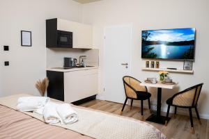 1 dormitorio con 1 cama y 1 mesa con sillas en Angelinas Service Apartment 4, en Oberhausen