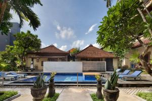 an image of a villa with a swimming pool at Legian Village Beach Resort - CHSE Certified in Legian