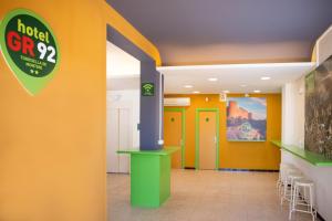 a lobby with colorful walls and a hotel grp sign at RVHotels GR92 in Torroella de Montgrí