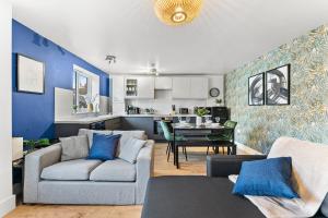 a living room with a couch and a table at The Augustine - Stylish City Centre Gem in Kent