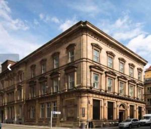 a large brick building on a city street at Fantastic Liverpool City Centre Apartments, Fenwick Street in Liverpool