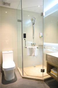 a bathroom with a shower and a toilet and a sink at City Comfort Inn Jiaxing Tongxiang Tongxing Avenue in Tongxiang