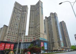 a group of tall buildings in a city at City Comfort Inn Huanggang Qichun Exhibition Center in Qichun