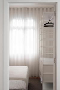 a bedroom with a bed and a white closet at Achada Sol in Funchal