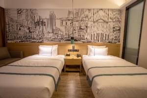 three beds in a room with a drawing on the wall at City Comfort Inn Shenyang Olympic Sports Center Wanda Plaza in Shenyang