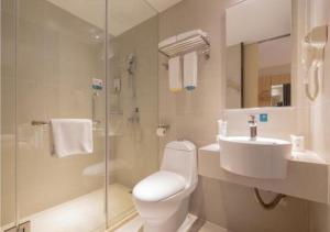 a bathroom with a toilet and a sink and a shower at City Comfort Inn Liuzhou Wuxing Walking Street in Liuzhou