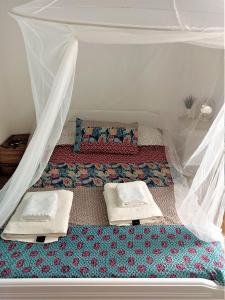 a bedroom with a bed with a canopy and pillows at La maison du Pêcheur in Kourélion