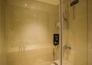 a shower with a glass door in a bathroom at City Comfort Inn Liuzhou Wuxing Walking Street Zhonghuan Tower in Liuzhou