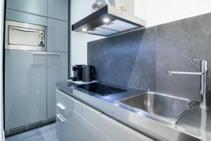 una cocina con fregadero y microondas en Viam 16b Suites, en Roma 30 fotos más