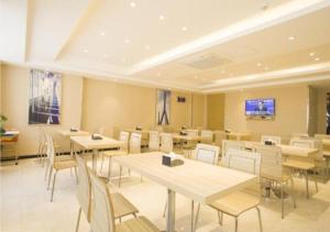 a dining room with tables and chairs at City Comfort Inn Zhanjiang South Railway Station in Zhanjiang