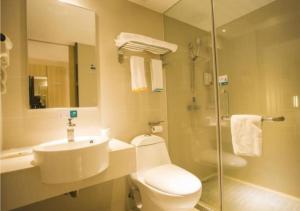 a bathroom with a toilet and a sink and a shower at City Comfort Inn Zhanjiang South Railway Station in Zhanjiang