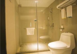 a bathroom with a toilet and a glass shower at City Comfort Inn Zhanjiang South Railway Station in Zhanjiang