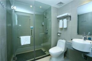 a bathroom with a toilet and a sink and a shower at City Comfort Inn Huangshi Daye Tongluowan Business Street in Daye