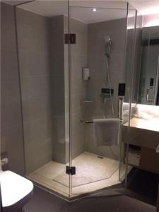 a shower in a bathroom with a toilet and a sink at City Comfort Inn Hefei Railway Station Metro Station in Qilitangzhen