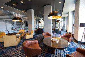 a lobby with a table and chairs at Hilton Garden Inn Savannah Historic District in Savannah