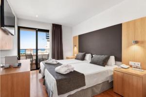 A bed or beds in a room at Hotel Principe Wellness&Spa