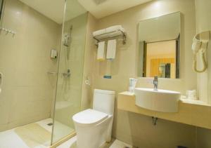 a bathroom with a toilet and a sink and a shower at City Comfort Inn Yibin Cuipingshan Park in Nanguang
