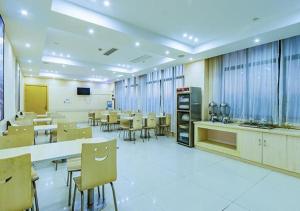 a large room with tables and chairs in a room at City Comfort Inn Hangzhou Xingqiao Bei Road in Yuhang