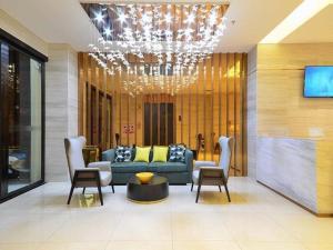 a living room with a couch and chairs and a chandelier at City Comfort Inn Yichang Shenxiwan Three Gorges Highway Intersection in Yichang