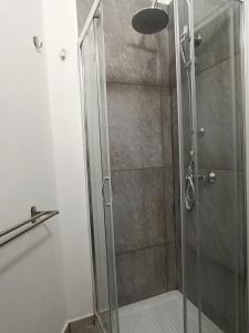 a shower with a glass door in a bathroom at B&B Napoli Fuorigrotta in Naples