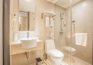 a bathroom with a toilet and a sink and a shower at City Comfort Inn Liuzhou Yaobu Acient Town in Liuzhou