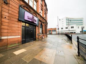 a building with a sign on the side of it at OYO Hotel Majestic in Lockerbie