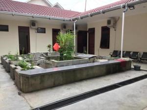 a house with a garden with plants in it at Hotel Meigah in Tanjungpandan