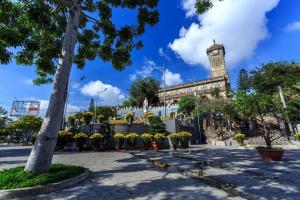 a building with a clock tower in the background at OPOX Nha Trang in Nha Trang