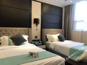 Ένα ή περισσότερα κρεβάτια σε δωμάτιο στο Xana Hotelle· Shijiazhuang Yaqing Street
