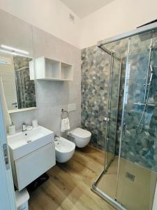 a bathroom with a shower and a sink and a toilet at La Maison in Grottammare