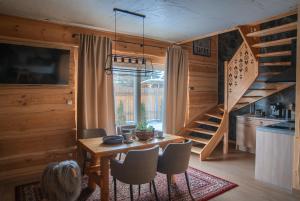 a kitchen and dining room with a table and a staircase at Domki Zajazd Furmański " Jacuzzi w ofercie dodatkowo płatnej" in Zakopane