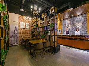 a restaurant with tables and chairs and a bar at James Joyce Coffetel· Xianyang Renmin Road Central Square Store in Xianyang