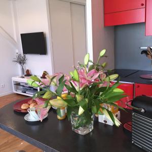 a vase of flowers on a table in a kitchen at Cannes Centre Palais du Festival in Cannes